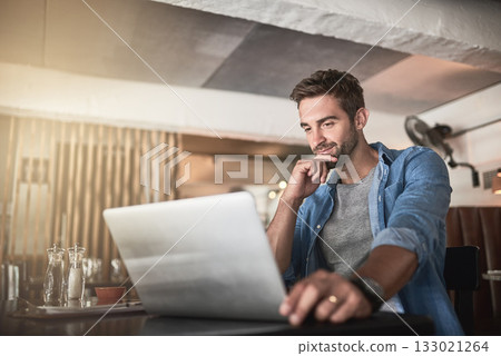 Thinking, laptop and man doing research in a coffee shop and reading for a freelance assignment. Pensive, technology and male freelancer working on a project with a computer at a cafe or restaurant. 133021264