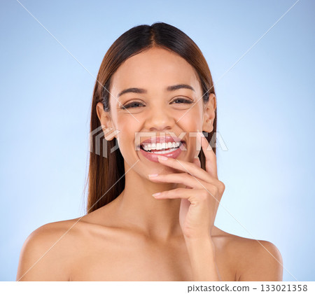 Portrait, skincare and woman with laugh, cosmetics and happiness against blue studio background. Face, Latino female and lady with smile, dermatology and morning routine for confidence and soft skin Portrait, skincare and woman with laugh, cosmetics and happiness against blue studio background. Face, Latino female and lady with smile, dermatology and morning routine for confidence and soft skin 133021358