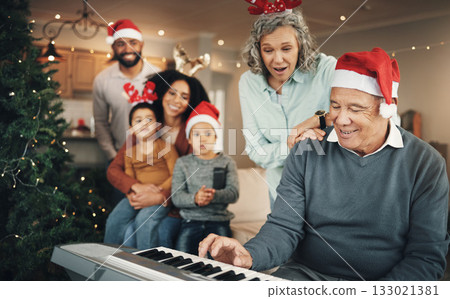 Family, christmas and senior man with piano in a living room for celebration, song and bond in their home. Music, instrument and retired pianist performing for kids and parents in festive celebration 133021381