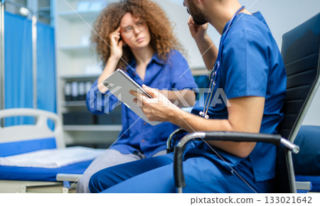 young woman consults a male doctor in a digital clinic. Medical diagnosis, concern, and professional care 133021642