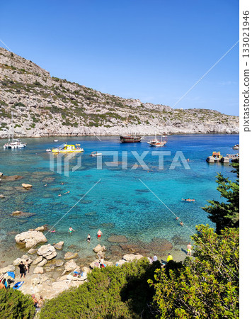 Enjoy breathtaking coastal views with crystal clear water and picturesque boats 133021946