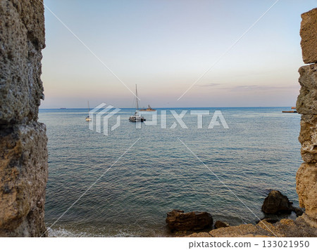 Enjoy a breathtaking scenic view of the vast sea as it beautifully stretches beyond ancient walls 133021950