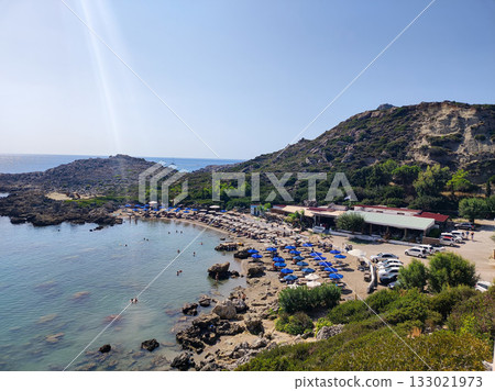 Discover a Beautiful Beach featuring Clear Waters, Comfortable Sun Beds, and Scenic Views 133021973