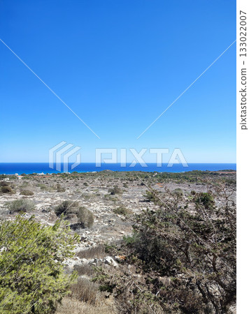 Stunning Scenic Coastal View Featuring a Clear Blue Sky Above the Calm Ocean Horizon 133022007
