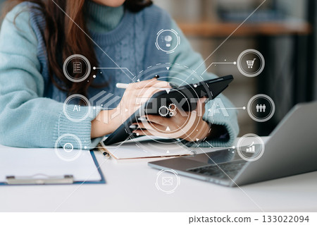 Businesswoman working with smart phone and laptop and digital tablet computer in office with digital marketing media Businesswoman working with smart phone and laptop and digital tablet computer in office with digital marketing media 133022094