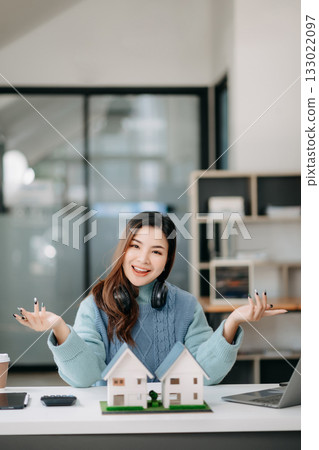 Young real estate agent worker working with laptop and tablet at table in office Young real estate agent worker working with laptop and tablet at table in office 133022097