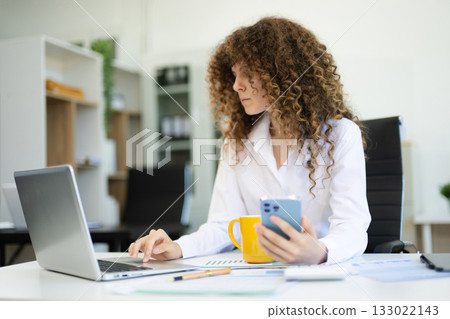 Successful business woman working on Financial and Marketing Projects. 133022143