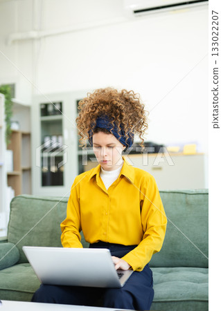 Beautiful caucasian woman working with laptop and papers 133022207