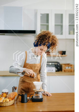 Caucasian barista brewing fresh espresso. Enjoy a cozy, trendy cafe experience with high quality beans in home or cafe 133022242