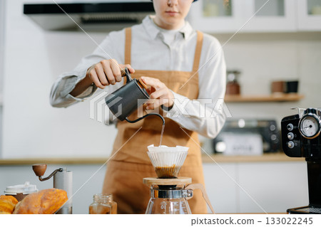 Closeup of barista brewing pour over coffee at home. Warm lifestyle concept featuring hand-crafted drip process, Closeup of barista brewing pour over coffee at home. Warm lifestyle concept featuring hand-crafted drip process, 133022245