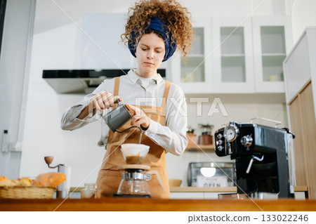 Caucasian barista brewing fresh espresso. Enjoy a cozy, trendy cafe experience with high quality beans in home or cafe Caucasian barista brewing fresh espresso. Enjoy a cozy, trendy cafe experience with high quality beans in home or cafe 133022246