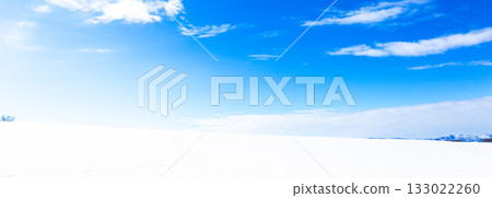 A simple winter landscape of blue skies, clouds, and snowy fields seen in Biei, Hokkaido A simple winter landscape of blue skies, clouds, and snowy fields seen in Biei, Hokkaido 133022260