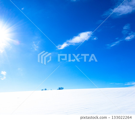 A simple winter landscape of blue skies, clouds, and snowy fields seen in Biei, Hokkaido A simple winter landscape of blue skies, clouds, and snowy fields seen in Biei, Hokkaido 133022264