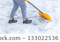 Man shoveling snow off of his driveway after a winter storm in Canada. Man with snow shovel cleans sidewalks in winter. Winter time. 133022536