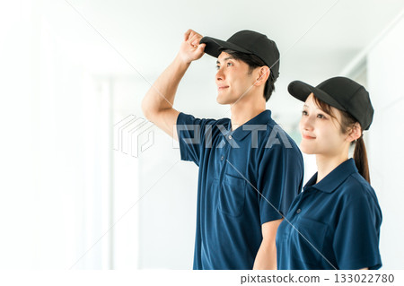 Cleaning staff in polo shirt uniforms, male and female workers (cleaning staff, building cleaning) 133022780
