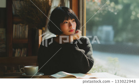 A woman reading at a cafe 133022948