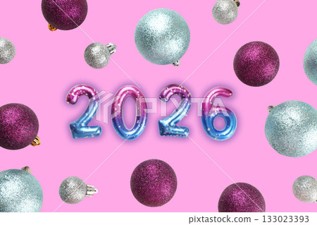Bright ornaments surround the number 2026 on a festive background 133023393