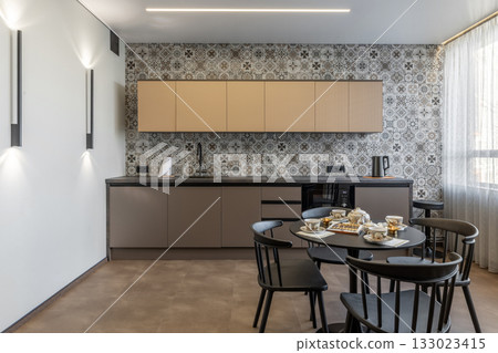 Cozy Modern Kitchen with Patterned Tiles and Black Furniture Cozy Modern Kitchen with Patterned Tiles and Black Furniture 133023415