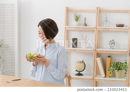 Woman eating salad Woman eating salad 133023451