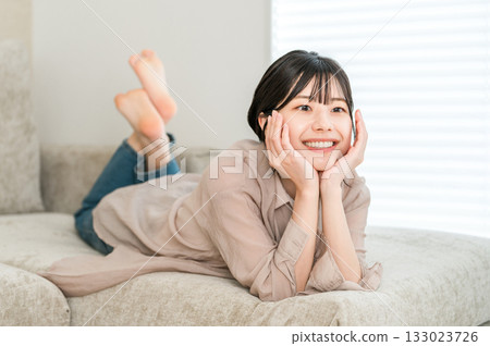 Young Asian woman relaxing on the sofa 133023726