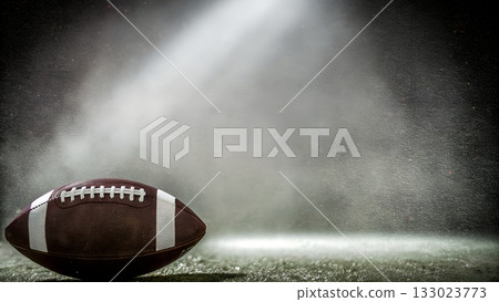 Get ready for game day with this dynamic football under the spotlight, perfect for sports promotions and team spirit Get ready for game day with this dynamic football under the spotlight, perfect for sports promotions and team spirit 133023773