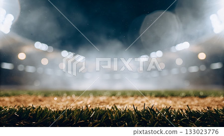 Experience the thrill of the game with this captivating sports field background under stadium lights at night Experience the thrill of the game with this captivating sports field background under stadium lights at night 133023776