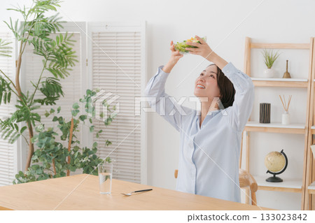 Woman holding up a salad Woman holding up a salad 133023842