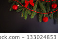 Christmas spruce branches with red ornaments and bows on black background. 133024853