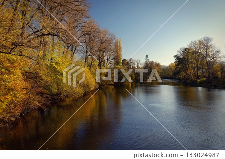 Autumn landscape with river and setting sun. Concept for nature and autumn time. Autumn landscape with river and setting sun. Concept for nature and autumn time. 133024987
