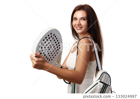 Smiling woman ready to play padel tennis with a racket and sport bag 133024997