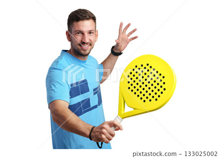 Man smiles while holding a yellow paddle racket ready for a game indoors Man smiles while holding a yellow paddle racket ready for a game indoors 133025002