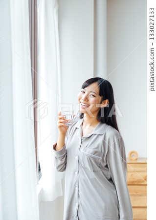 A young woman's well-being-conscious lifestyle: Morning routine of drinking water A young woman's well-being-conscious lifestyle: Morning routine of drinking water 133027133