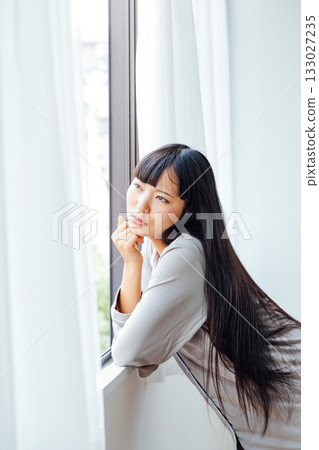 Gloomy morning image of a grumpy young woman Gloomy morning image of a grumpy young woman 133027235