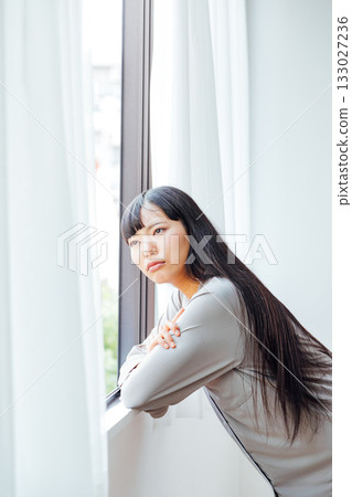 Gloomy morning image of a grumpy young woman Gloomy morning image of a grumpy young woman 133027236