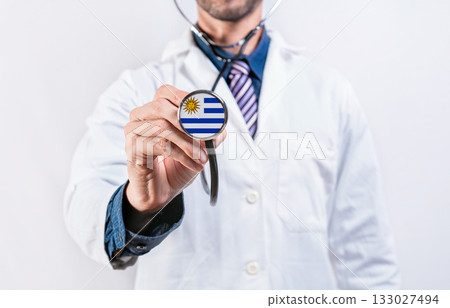 Uruguay healthcare system, doctor holding stethoscope. Uruguay health and medical insurance concept Uruguay healthcare system, doctor holding stethoscope. Uruguay health and medical insurance concept 133027494
