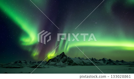 A curtain of light spreads across a starry snowy field 133028861