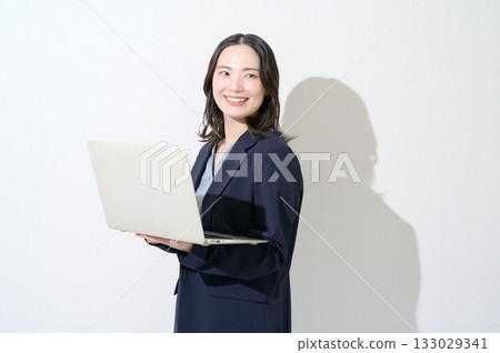 Japanese woman holding a laptop on a white background 133029341