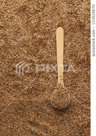 flax seeds for sowing in a wooden spoon, close up, a large number of light brown flax seeds and a wooden spoon with seeds flax seeds for sowing in a wooden spoon, close up, a large number of light brown flax seeds and a wooden spoon with seeds 133029870