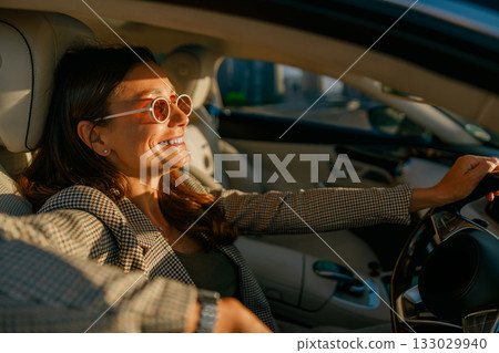 Selfassured female driver reflecting city hustle and professional drive Selfassured female driver reflecting city hustle and professional drive 133029940