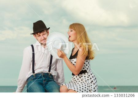 Loving couple retro style dating on sea coast 133031206