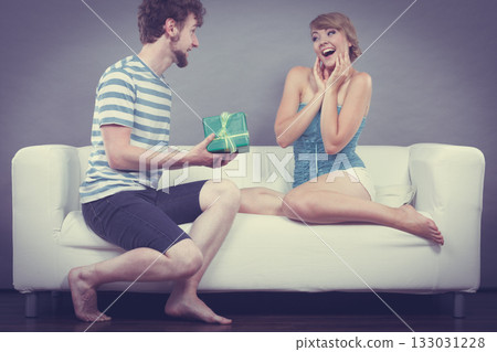 Young man giving woman gift box 133031228