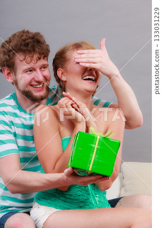 Young man giving woman gift box Young man giving woman gift box 133031229