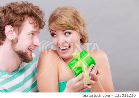 Young man giving woman gift box Young man giving woman gift box 133031230
