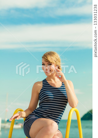 Fashion woman in striped dress outdoor. Summer. 133031238