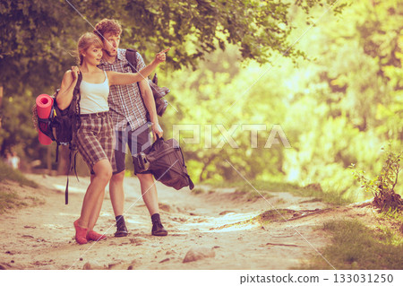 Hiking young couple with guitar backpack outdoor Hiking young couple with guitar backpack outdoor 133031250