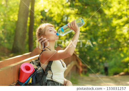 Tourist woman with backpack water bottle Tourist woman with backpack water bottle 133031257