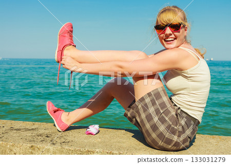 woman hiker relaxing on sea coast 133031279