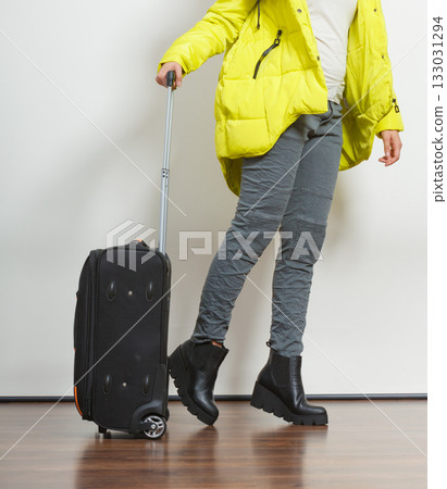 Woman in warm jacket with suitcase. Woman in warm jacket with suitcase. 133031294