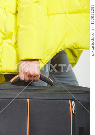 Woman in warm jacket with suitcase. Woman in warm jacket with suitcase. 133031295