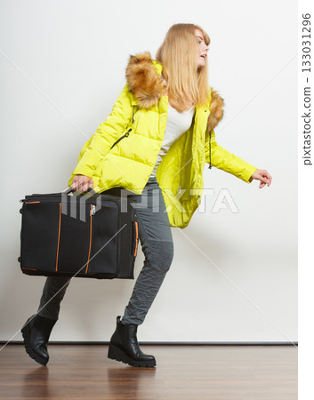Young woman in warm jacket with suitcase. Young woman in warm jacket with suitcase. 133031296
